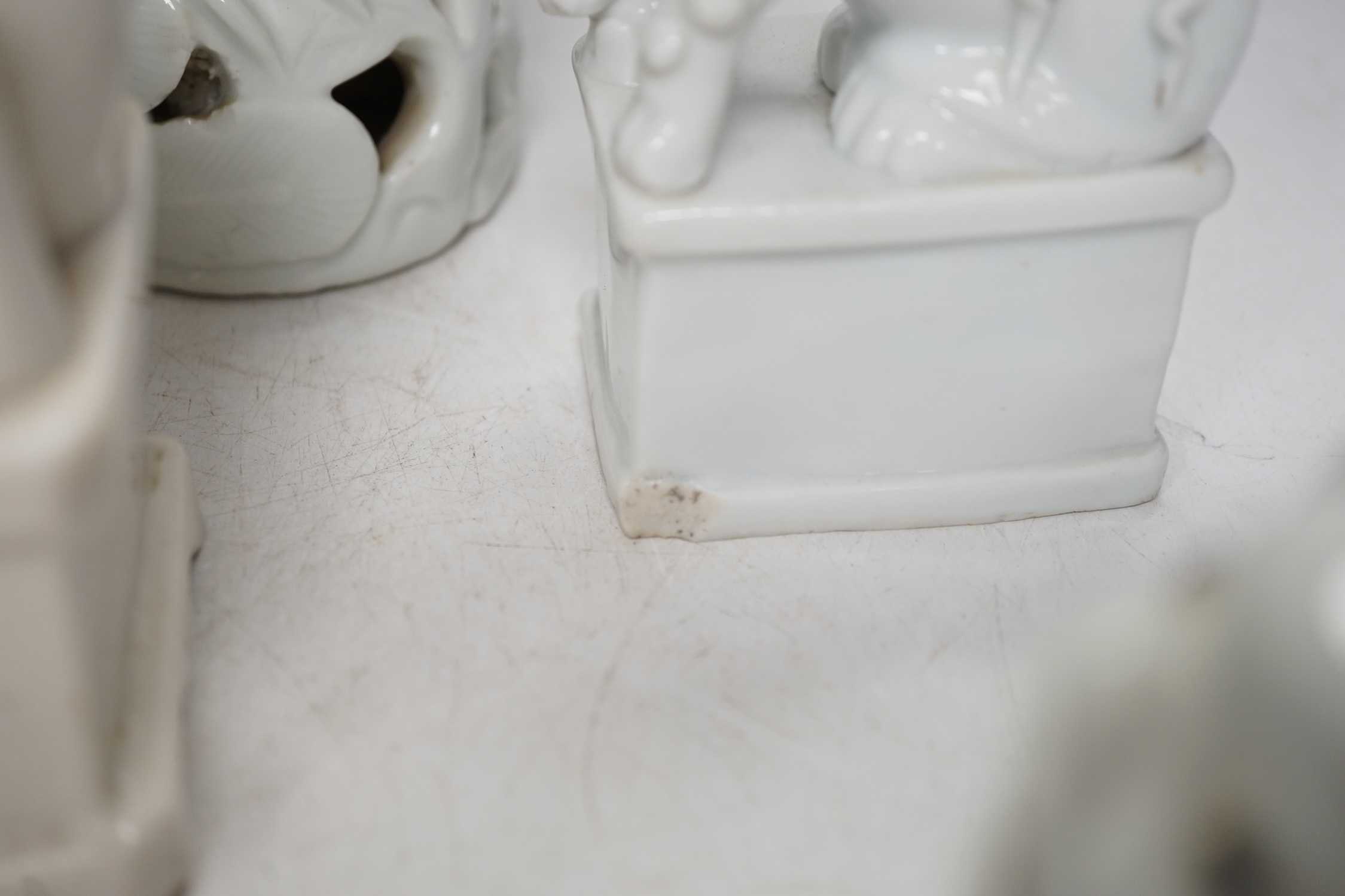 Seven Chinese blanc de chine pieces to include a pair of lion dogs and a phoenix, 17th century and later, largest 44cm high. Condition - varies, poor to fair